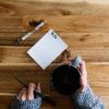Writing out home build checklist on legal pad.