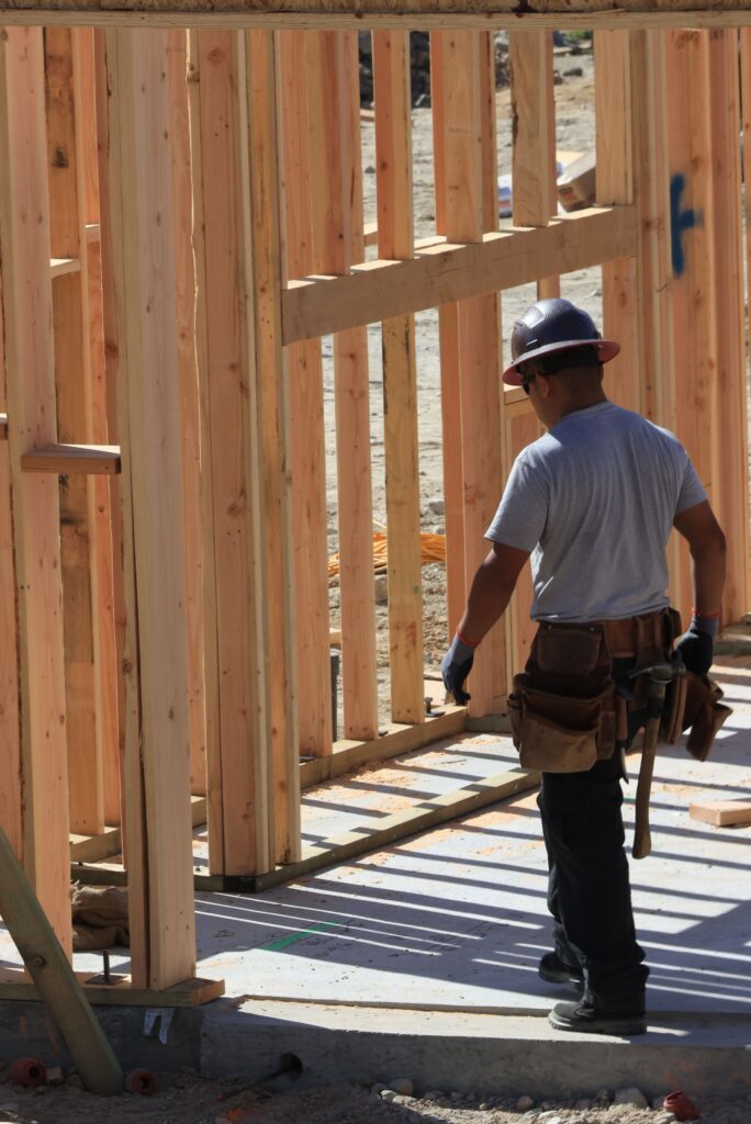 A home builder faces the framing of a custom home build.